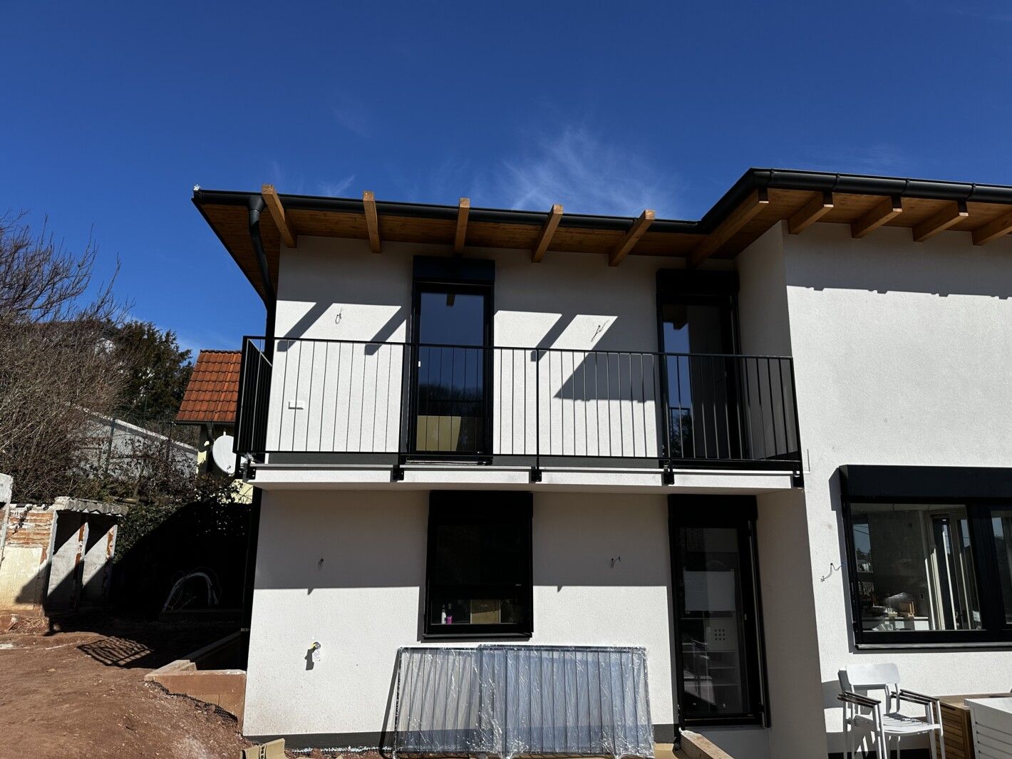 Ein Edelstahl Stabgeländer an einem neuen, hellen Einfamilienhaus