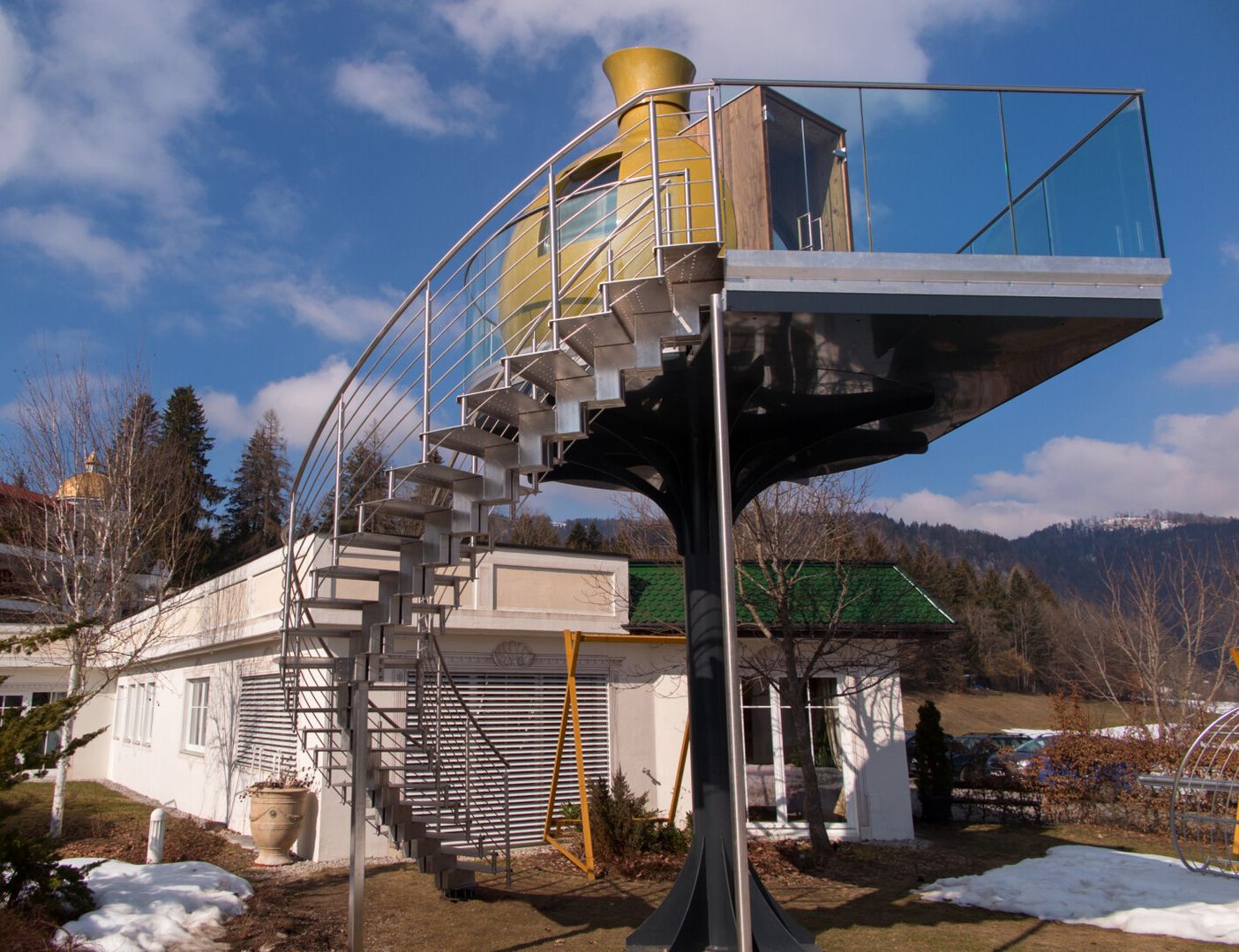 Eine Doppelmittelholmtreppe, die zu einem Bodest mit gelben Gebäude führt