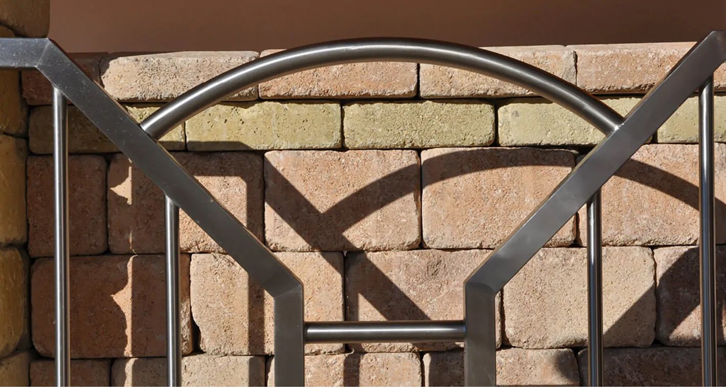 Eine ästhetische Edelstahl Tür vor einer Steinwand